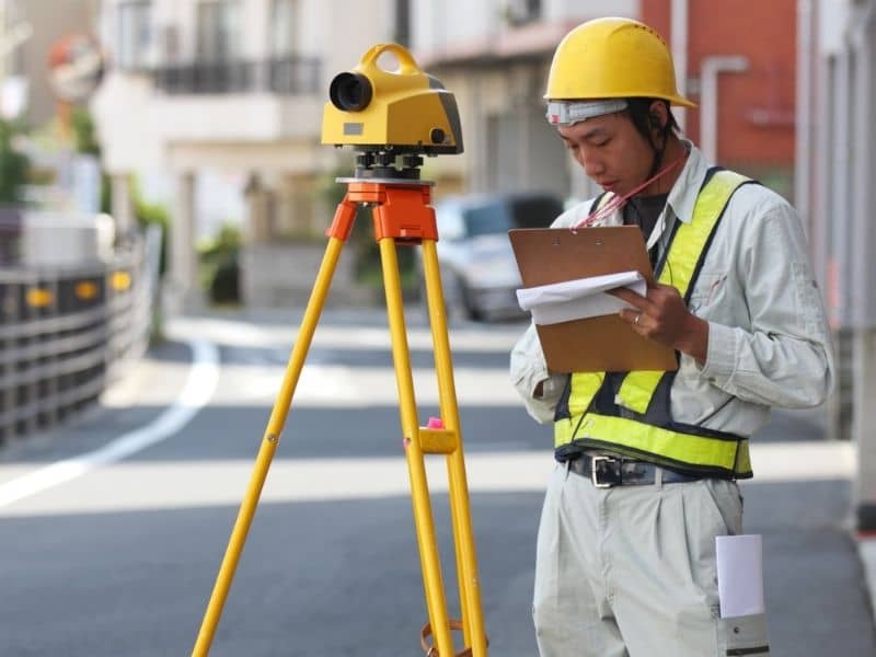 ALTA surveyor documenting site conditions for a commercial redevelopment project
